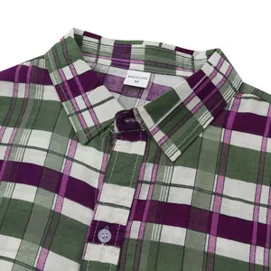 Close-up macro detail of green and purple plaid beach shirt collar with size M label