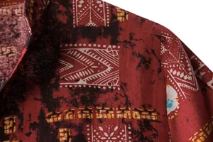 Close-up of men's casual beach shirt with vintage geometric print and fabric texture.