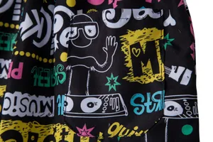 Macro view of men's quick-dry beach shorts featuring colorful graffiti print and pocket.