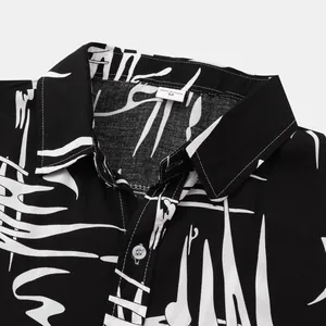 Close-up detail of a men's shirt with abstract black and white pattern and collar.