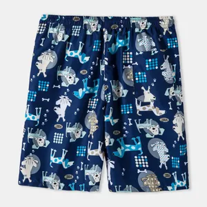 Detailed back view of navy blue men's beach shorts with cute cartoon dog patterns