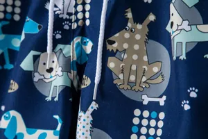 Close-up of men's navy blue beach shorts with cartoon dog pattern and drawstrings