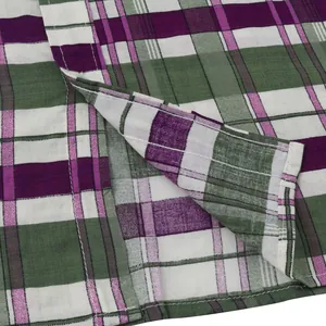 Close-up macro view of green and purple plaid fabric texture on a men beach shirt