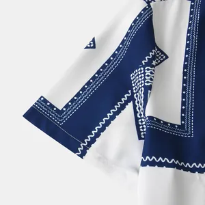 Close-up detail of ethnic geometric pattern on men's blue and white short sleeve shirt