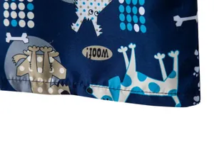 Detailed view of the stitching and fabric texture on men's beach shorts with dog print