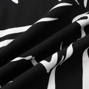 Macro detail of black and white abstract pattern fabric for men's slim fit shirt