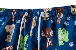 Detailed view of the elastic waistband and drawstring on cartoon dog print men's beach shorts.