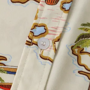 Macro view of men's tropical print shirt detailing white button and fabric texture