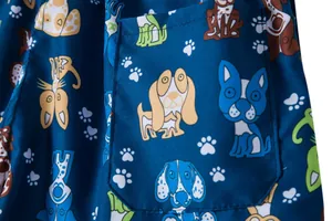 Close-up of the cartoon dog pattern and fabric texture on navy blue beach shorts