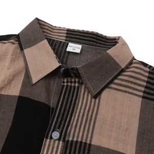 Close-up detail of the collar and brown plaid fabric on a men's casual Hawaiian shirt