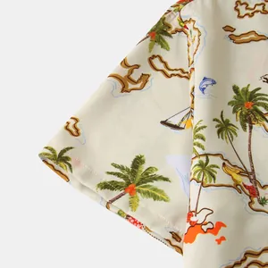 Close-up detail of tropical palm tree and map print on men's casual short sleeve shirt