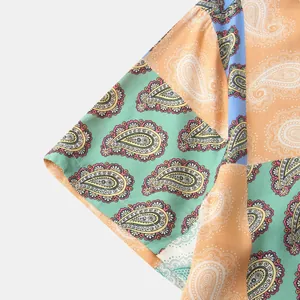 Close-up of vibrant paisley and floral print on lightweight men's summer shirt sleeve.