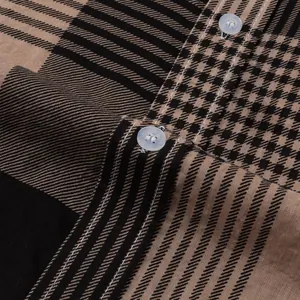 Macro view of houndstooth and striped fabric on a men's casual Hawaiian beach shirt.