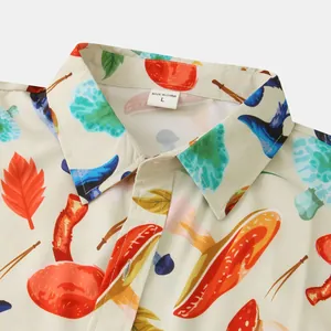 Macro detail of men's casual short sleeve shirt featuring colorful mushroom and leaf patterns
