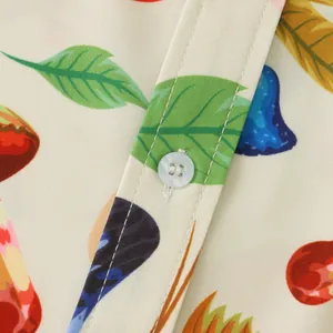 Detail of tropical leaf print and button on a men's summer casual slim fit shirt