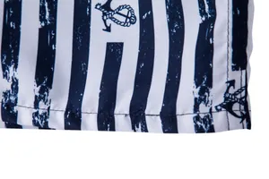 Close-up of anchor pattern on striped men's beach shorts