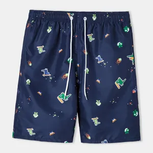 Detail view of navy blue men's swim trunks with colorful pixel dinosaur patterns