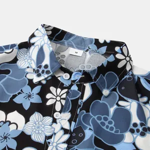 Close-up of men's tropical floral short sleeve shirt collar and blue print detail