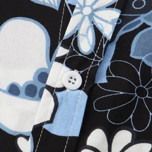 Close-up macro view of white button and blue floral print detail on men's summer shirt fabric