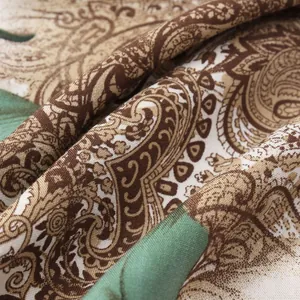 Macro detail of men's shirt fabric featuring vintage brown paisley and green stripes