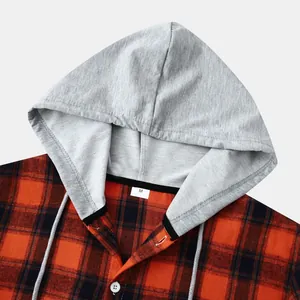 Close-up detail of grey hood and orange plaid texture on men's flannel hooded shirt