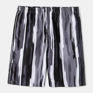 Detail view of men's quick-dry swimming trunks with black and white brushstroke pattern