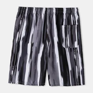 Back view of men's breathable beach shorts featuring black and grey brushstroke stripes