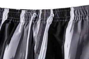 Detailed macro view of the elastic waistband and white drawstring on striped beach shorts