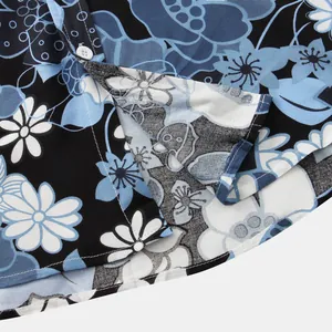 Macro view of vibrant blue and white floral pattern on a men's summer short-sleeve shirt