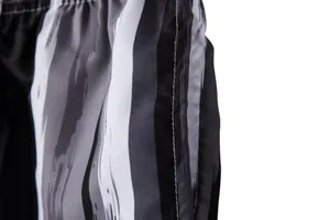 Close-up detail of black and white brushstroke pattern on quick-dry beach shorts