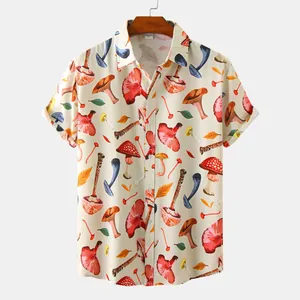 Detailed view of men's short sleeve shirt featuring colorful mushroom print on beige fabric.