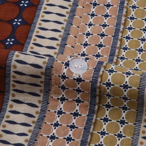 Detailed close-up showing retro geometric pattern on a men's beach shirt fabric