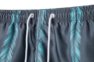 Close-up detail of elastic waistband and white drawstring on palm print beach shorts