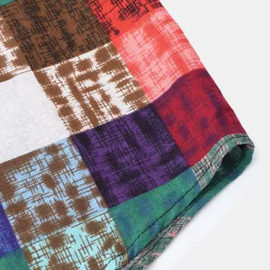 Macro view of colorful ethnic patchwork fabric texture on men's casual shirt