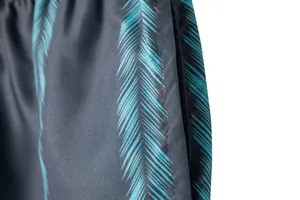 Close-up detail view of side pocket and teal palm leaf print on summer beach shorts