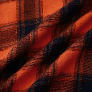 Close-up detail of orange and navy blue plaid flannel fabric texture for men shirt
