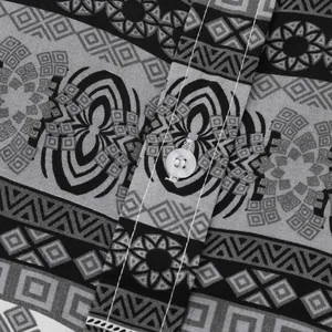 Close-up of geometric pattern and white button on men's ethnic style short sleeve shirt