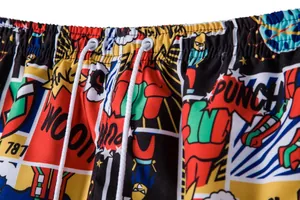 Detailed macro shot of comic print men's beach shorts featuring elastic drawstring waistband