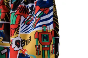 Detail view showing the vibrant comic print and pocket stitching of men's swim shorts