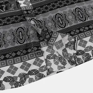 Close-up detail of men's short sleeve shirt with monochrome ethnic geometric pattern