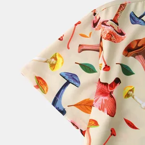 Detailed close-up showing vibrant mushroom and leaf print on a men's casual short sleeve shirt