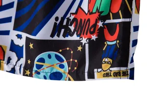 Detail close-up of men's beach shorts featuring vibrant comic-style print design