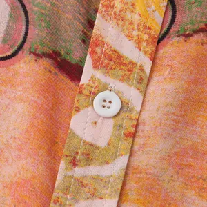 Macro detail of white button and colorful floral fabric on men's summer shirt