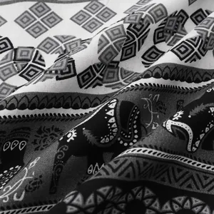 Detailed close-up of ethnic elephant and geometric pattern fabric for men's shirts