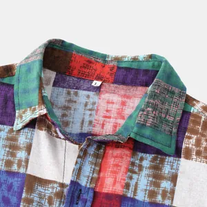 Close-up of men's ethnic patchwork shirt collar showing fabric texture and color detail.