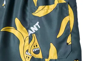 Macro view of the pocket detail on men's beach shorts with a funny banana print pattern
