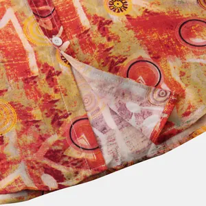 Macro view showing the hem stitching and button of a men's ethnic print summer shirt
