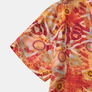 Detail shot of men's short sleeve shirt showing vibrant ethnic patterns and fabric texture