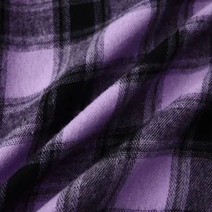 Macro view of purple and black plaid fabric texture with soft woven finish