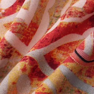 Close-up of vibrant red and yellow geometric print fabric for men's summer shirt
